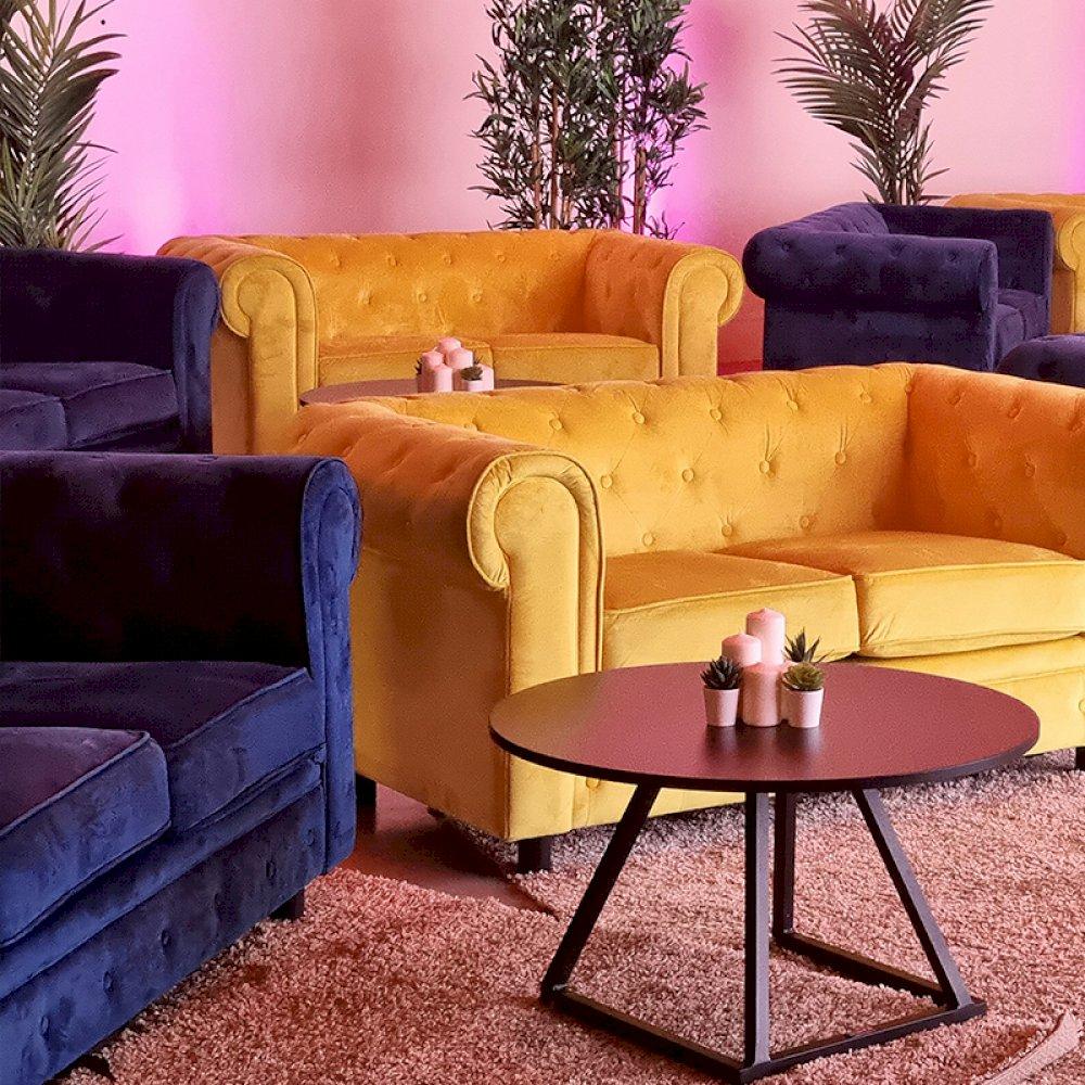 Comfy Chesterfield sofas in mustard and royal blue to create a secret cinema soft seating area.