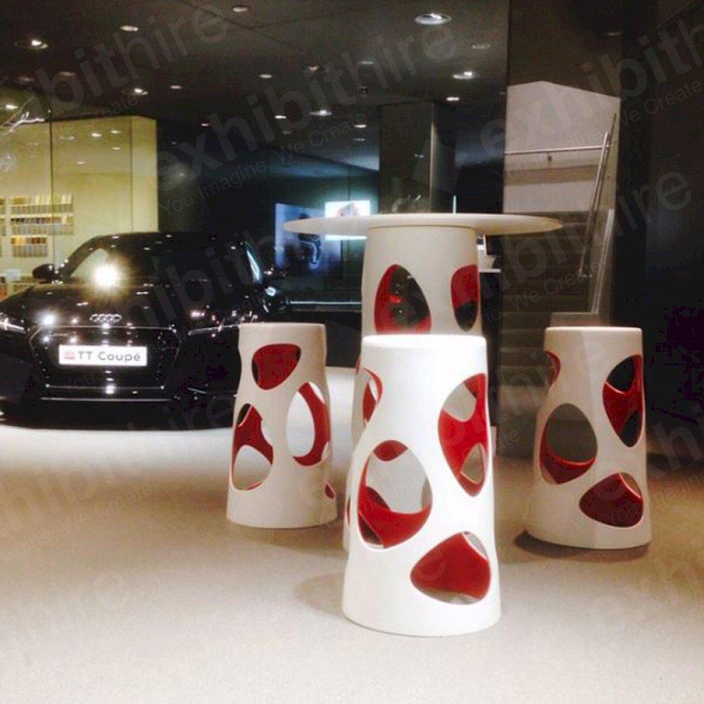 The Vega range includes tables and stools available in red or purple.