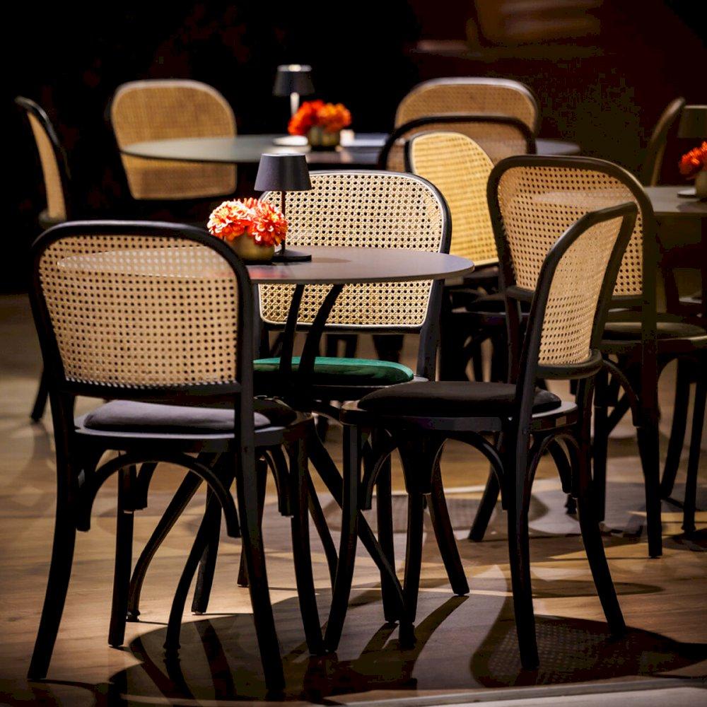 Featured: Cane back chairs with black and green pads.